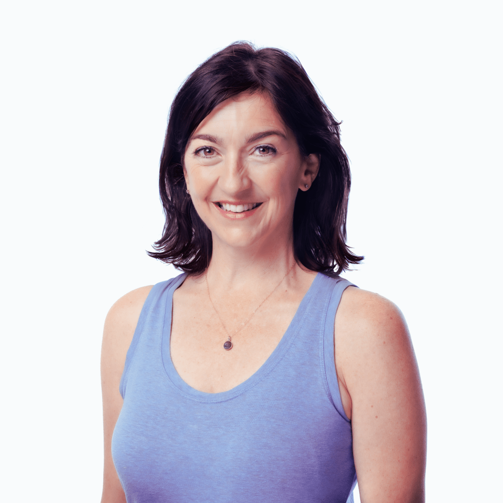 Photo of smiling brunette woman in a lavender shirt.
